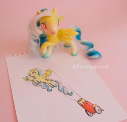 Size: 1080x1036 | Tagged: safe, artist:beccaintoyland, oc, unnamed oc, pegasus, pony, g4, g4.5, cannon, circus, clown, copic, curly mane, customized toy, drawing, facial markings, irl, party cannon, photo, pony cannonball, red eyes, solo, toy, traditional art