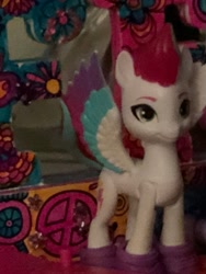 Size: 827x1098 | Tagged: safe, zipp storm, pegasus, pony, g5, bff decoration, clothes, cropped, decoration, female, flower, gem, illogical, irl, joke, last man standing, last man standing challenge, last pony standing, last pony standing challenge, looking at you, mare, nonsense, owl on decoration, peace sign, photo, random, shoes, skateboard, smiling, smiling at you, solo, story included, toy, why