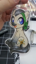 Size: 1152x2048 | Tagged: safe, artist:inkkeystudios, oc, oc only, earth pony, human, pony, badge, ear piercing, earring, eye clipping through hair, irl, irl human, jewelry, open mouth, open smile, photo, piercing, sitting, smiling, solo, traditional art, unshorn fetlocks