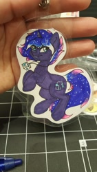 Size: 1152x2048 | Tagged: safe, artist:inkkeystudios, oc, oc only, pony, unicorn, badge, ethereal mane, eye clipping through hair, galaxy mane, jewelry, looking at you, necklace, pendant, photo, smiling, solo, traditional art