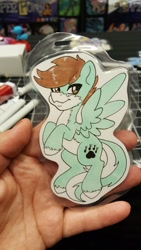 Size: 1152x2048 | Tagged: safe, artist:inkkeystudios, oc, oc only, human, pegasus, pony, :3, badge, irl, irl human, looking at you, photo, smiling, solo, spread wings, traditional art, unshorn fetlocks, wings