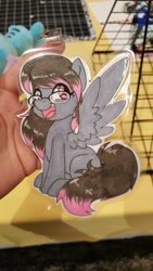 Size: 1152x2048 | Tagged: safe, artist:inkkeystudios, oc, oc only, pegasus, pony, badge, eye clipping through hair, glasses, happy, looking at you, open mouth, open smile, photo, sitting, smiling, solo, spread wings, traditional art, wings
