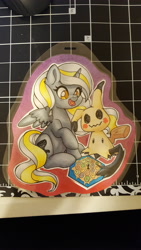 Size: 5312x2988 | Tagged: safe, artist:inkkeystudios, alicorn, mimikyu, pony, badge, board game, open mouth, open smile, photo, pokémon, smiling, spread wings, traditional art, wings