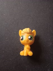 Size: 3120x4160 | Tagged: safe, photographer:hollyn, applejack, earth pony, pony, g4, baby, baby pony, babyjack, foal, photo, solo, toy, younger