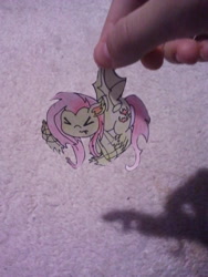 Size: 480x640 | Tagged: safe, artist:fluttersdoodles, fluttershy, bat pony, pegasus, pony, g4, ><, bat ponified, eyes closed, female, fingers, flutterbat, holding a pony, irl, paper child, photo, race swap, solo, traditional art