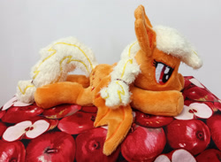 Size: 3182x2324 | Tagged: safe, artist:basil_leafeon, applejack, bat pony, pony, g4, applebat, bat ponified, bat wings, beanie (plushie), female, high res, irl, lying down, mare, photo, plushie, prone, race swap, wings