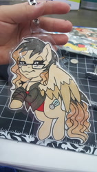 Size: 5312x2988 | Tagged: safe, artist:inkkeystudios, oc, oc only, pegasus, pony, badge, clothes, colored wings, colored wingtips, glasses, jacket, jewelry, lidded eyes, looking at you, necklace, photo, solo, traditional art, two toned wings, unamused, wings