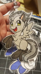 Size: 5312x2988 | Tagged: safe, artist:inkkeystudios, oc, oc only, pegasus, pony, badge, clothes, looking at you, open mouth, open smile, paw socks, photo, smiling, socks, solo, spread wings, traditional art, wings