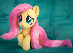 Size: 1984x1446 | Tagged: safe, artist:buttercupbabyppg, fluttershy, pegasus, pony, g4, cute, female, folded wings, irl, lying down, mare, photo, plushie, prone, shyabetes, smiling, solo, wings