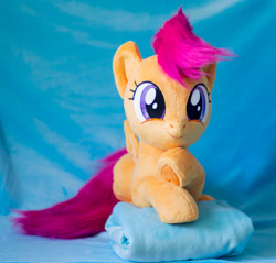 Size: 1441x1375 | Tagged: safe, artist:buttercupbabyppg, scootaloo, pegasus, pony, g4, female, filly, foal, happy, irl, lying down, photo, plushie, prone, smiling, solo, spread wings, wings