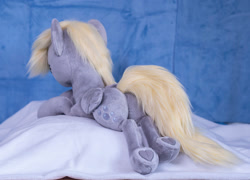 Size: 1397x1007 | Tagged: safe, artist:buttercupbabyppg, derpy hooves, pegasus, pony, g4, eyes closed, female, folded wings, happy, irl, lying down, mare, photo, plushie, prone, sleeping, wings