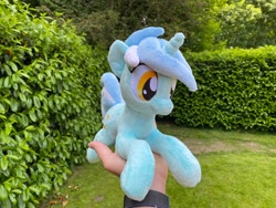 Size: 2048x1536 | Tagged: safe, artist:rtryart, lyra heartstrings, pony, unicorn, g4, female, happy, horn, irl, lying down, mare, outdoors, photo, plushie, prone, smiling, solo