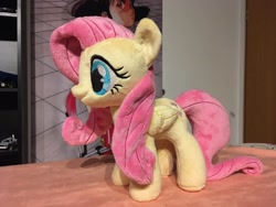 Size: 2048x1536 | Tagged: safe, artist:rtryart, fluttershy, pegasus, pony, g4, female, folded wings, irl, mare, photo, plushie, smiling, solo, standing, wings