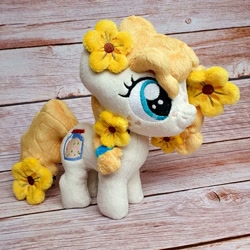 Size: 1200x1200 | Tagged: safe, artist:straycatcrafts, pear butter, earth pony, pony, g4, female, filly, flower, foal, hair tie, happy, irl, photo, plushie, smiling, solo, younger