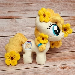 Size: 1200x1200 | Tagged: safe, artist:straycatcrafts, pear butter, earth pony, pony, g4, female, filly, flower, foal, hair tie, happy, irl, photo, plushie, smiling, solo, younger