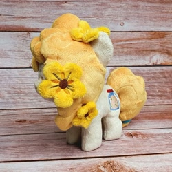 Size: 1200x1200 | Tagged: safe, artist:straycatcrafts, pear butter, earth pony, pony, g4, female, filly, flower, foal, hair tie, happy, irl, photo, plushie, smiling, solo, younger