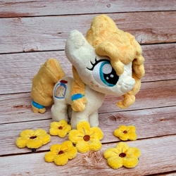 Size: 1200x1200 | Tagged: safe, artist:straycatcrafts, pear butter, earth pony, pony, g4, female, filly, flower, foal, hair tie, happy, irl, photo, plushie, smiling, solo, younger