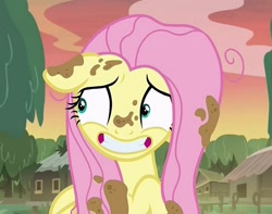 Size: 817x644 | Tagged: safe, screencap, fluttershy, pegasus, pony, a health of information, g4, cropped, dirt, female, floppy ears, grin, mare, mud, nervous, nervous smile, smiling, solo