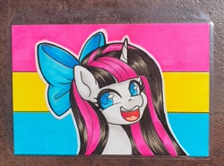 Size: 2491x1839 | Tagged: safe, artist:inkkeystudios, pony, unicorn, badge, bow, hair bow, happy, looking at you, open mouth, open smile, pansexual pride flag, photo, pride, pride flag, smiling, solo, traditional art