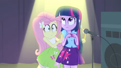 Size: 3072x1727 | Tagged: safe, screencap, fluttershy, twilight sparkle, human, equestria girls, g4, my little pony equestria girls: rainbow rocks, bare shoulders, clothes, cute, cutie mark on clothes, duo, duo female, female, fluttershy's skirt, frown, hairpin, microphone, microphone stand, musical instrument, shyabetes, skirt, sleeveless, spotlight, tambourine, twilight sparkle's skirt