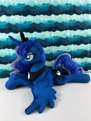Size: 4032x3024 | Tagged: safe, artist:kazzysart, princess luna, alicorn, pony, g4, craft, crown, ethereal mane, ethereal tail, female, irl, jewelry, lying down, mare, multicolored mane, multicolored tail, peytral, photo, plushie, prone, regalia, smiling, solo, spread wings, tail, wings