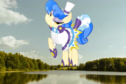 Size: 6000x4000 | Tagged: safe, anonymous editor, artist:dashiesparkle, edit, sapphire shores, earth pony, pony, g4, absurd resolution, clothes, female, giant pony, giantess, hat, highrise ponies, irl, lake, looking at you, macro, mare, photo, ponies in real life, raised hoof, scenery, smiling, solo, tree, water