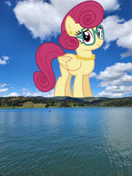 Size: 1920x2560 | Tagged: safe, anonymous editor, artist:cheezedoodle96, edit, posey shy, pegasus, pony, g4, female, folded wings, giant pony, giantess, glasses, high res, highrise ponies, irl, jewelry, macro, mare, mountain, mountain range, necklace, pearl necklace, photo, ponies in real life, solo, water, wings