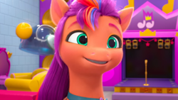 Size: 1366x768 | Tagged: safe, screencap, sunny starscout, earth pony, pony, bridlewoodstock (make your mark), g5, my little pony: make your mark, my little pony: make your mark chapter 4, spoiler:my little pony: make your mark chapter 4, spoiler:mymc04e01, brick wall, bridlewoodstock, female, indoors, mane stripe sunny, mare, microphone, orange skin, png, purple mane, scenery, smiling, solo, speaker, turquoise eyes, wall