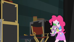 Size: 1280x720 | Tagged: safe, screencap, pinkie pie, spike, spike the regular dog, dog, human, equestria girls, equestria girls specials, g4, my little pony equestria girls: movie magic, backing away, bracelet, clothes, duo, female, grin, holding, holding a dog, jewelry, male, nervous, nervous smile, shirt, skirt, smiling, teenager