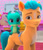 Size: 1052x1234 | Tagged: safe, screencap, hitch trailblazer, sparky sparkeroni, dragon, earth pony, pony, a little horse, g5, my little pony: make your mark, my little pony: make your mark chapter 4, spoiler:g5, baby, baby dragon, cropped, disapproval, frown, male, sash, smiling, sparky sparkeroni is not amused, stallion, unamused, upset