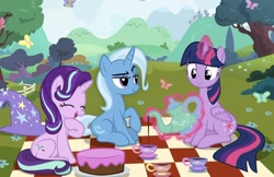 Size: 1016x660 | Tagged: source needed, safe, gameloft, starlight glimmer, trixie, twilight sparkle, alicorn, butterfly, pony, unicorn, g4, cake, cup, fence, food, glowing, glowing horn, horn, magic, magic aura, nature, picnic blanket, sitting, teacup, teapot, telekinesis, tree, trio, twilight sparkle (alicorn)
