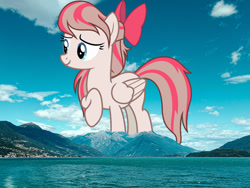 Size: 1280x960 | Tagged: safe, anonymous editor, artist:pink1ejack, edit, angel wings, pegasus, pony, g4, bow, female, giant pony, giantess, hair bow, highrise ponies, irl, macro, mare, mountain, mountain range, nature, photo, ponies in real life, smiling, solo, water
