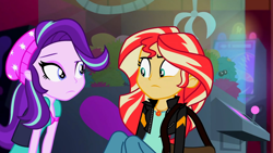 Size: 3072x1727 | Tagged: safe, screencap, starlight glimmer, sunset shimmer, human, equestria girls, equestria girls specials, g4, my little pony equestria girls: mirror magic, beanie, canterlot mall, cinema, clothes, duo, duo female, female, frown, geode of empathy, hat, jacket, jewelry, leather, leather jacket, looking at each other, looking at someone, magical geodes, necklace