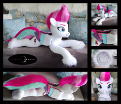 Size: 1280x1106 | Tagged: safe, artist:purplenebulastudios, zipp storm, pegasus, pony, g5, adorazipp, colored wings, colored wingtips, couch, cute, eyebrows, female, fluffy, folded wings, hoof heart, irl, lying down, mare, photo, pillow, plushie, prone, raised eyebrow, raised eyebrows, smiling, solo, underhoof, unshorn fetlocks, wings