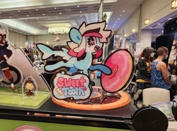 Size: 3477x2592 | Tagged: safe, artist:mushwoomy, oc, oc:sweet_tooth, original species, shark, shark pony, acrylic plastic, convention, donut, food, high res, irl, no source available, photo, sharp teeth, teeth, text