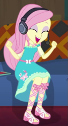Size: 281x520 | Tagged: safe, screencap, fluttershy, human, equestria girls, g4, game stream, my little pony equestria girls: better together, clothes, couch, cropped, cute, dress, excited, eyeshadow, fluttershy boho dress, gamer fluttershy, happy, headphones, makeup, pink eyeshadow, shyabetes, solo, sunset's apartment