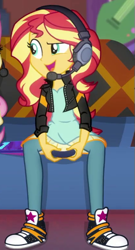 Size: 277x512 | Tagged: safe, screencap, sunset shimmer, human, equestria girls, g4, game stream, spoiler:eqg series (season 2), clothes, controller, couch, cropped, cute, dress, gamer sunset, headphones, jacket, leather, leather jacket, looking at someone, pants, shimmerbetes, smiling, solo focus, sunset's apartment, trainers