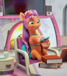 Size: 1337x1518 | Tagged: safe, screencap, sunny starscout, earth pony, pony, a little horse, g5, my little pony: make your mark, my little pony: make your mark chapter 4, spoiler:g5, spoiler:my little pony: make your mark, spoiler:my little pony: make your mark chapter 4, spoiler:mymc04e06, bag, belly, blurry, book, chair, crystal brighthouse, cute, female, hoof hold, mane stripe sunny, mare, phone, photo, picture of a screen, saddle bag, sitting like a human, sunnybetes, television