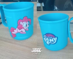Size: 601x489 | Tagged: safe, artist:yappwikia alicorn-stevonnie fandom, derpibooru exclusive, pinkie pie, earth pony, pony, g4, cup, female, irl, mare, merchandise, my little pony logo, photo, smiling, solo, table, text, workplace