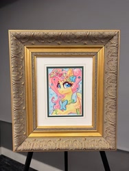 Size: 1536x2048 | Tagged: safe, artist:dandy, fluttershy, butterfly, pony, g4, babscon, blushing, butterfly hairpin, clothes, cute, dress, ear fluff, female, flower, flower in hair, framed picture, gala dress, heart, heart eyes, looking at you, mare gallery, photo, shyabetes, smiling, smiling at you, solo, traditional art, watercolor painting, wingding eyes