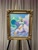 Size: 1536x2048 | Tagged: safe, artist:dandy, princess celestia, alicorn, pony, mare fair, g4, acrylic painting, cloud, crown, eyeshadow, female, framed picture, hair over one eye, horn, jewelry, looking at you, makeup, mare, mare gallery, painting, photo, raised hoof, regalia, sky, smiling, solo, traditional art, wings