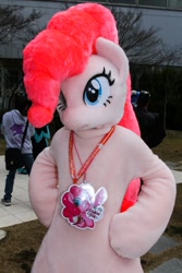 Size: 600x900 | Tagged: safe, pinkie pie, 2018, badge, fursuit, hooves on hips, irl, outdoors, photo, ponysuit, solo focus