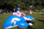 Size: 640x426 | Tagged: safe, artist:atalonthedeer, firefly, human, whale, g1, 2012, blue inflatable whale, connichi, fursuit, grass, grass field, inflatable, inflatable whale, inflatable world, irl, irl human, lying down, opaque blue inflatable whale, opaque inflatable, outdoors, photo, ponysuit, prone, solo focus