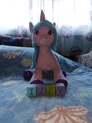 Size: 2448x3264 | Tagged: safe, izzy moonbow, original species, plush pony, unicorn, g5, alphabet, building blocks, cute, female, horn, indoors, irl, izzybetes, mare, name, photo, plushie, solo