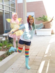 Size: 525x700 | Tagged: safe, artist:xsoulxxxreaperx, fluttershy, rainbow dash, human, g4, boots, brick wall, bricks, clothes, cosplay, costume, duo, duo female, female, irl, irl human, outdoors, photo, plant, rainbow socks, shoes, socks, striped socks