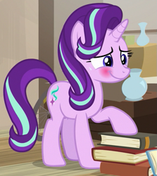 Size: 567x636 | Tagged: safe, screencap, starlight glimmer, pony, unicorn, g4, my little pony: friendship is magic, season 7, uncommon bond, blushing, book, cropped, cute, embarrassed, female, glimmerbetes, horn, indoors, mare, raised hoof, smiling, solo