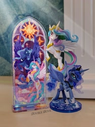 Size: 2126x2834 | Tagged: safe, kotobukiya, princess celestia, princess luna, alicorn, g4, official, acrylic plastic, acrylic standee, craft, duo, indoors, kotobukiya princess celestia, kotobukiya princess luna, looking at each other, looking at someone, looking at you, merchandise, spread wings, stained glass, stars, sun, wings