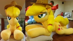 Size: 4032x2268 | Tagged: safe, artist:ponimalion, applejack, pony, g4, bedroom eyes, female, irl, lidded eyes, life size, mare, photo, pillow, plushie, smiling, tail