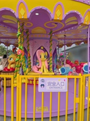 Size: 4124x5499 | Tagged: safe, applejack, fluttershy, pinkie pie, spike, pony, g4, official, apple, carousel, chinese, food, front view, irl, looking at you, open mouth, party cannon, photo, sitting, spread wings, statue, swing, text, wings