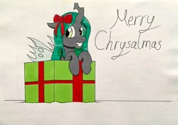 Size: 3500x2445 | Tagged: safe, artist:killerteddybear94, queen chrysalis, changeling, changeling queen, pony, g4, bow, box, christmas, cute, cutealis, hair bow, holiday, looking at you, pony in a box, present, pun, traditional art